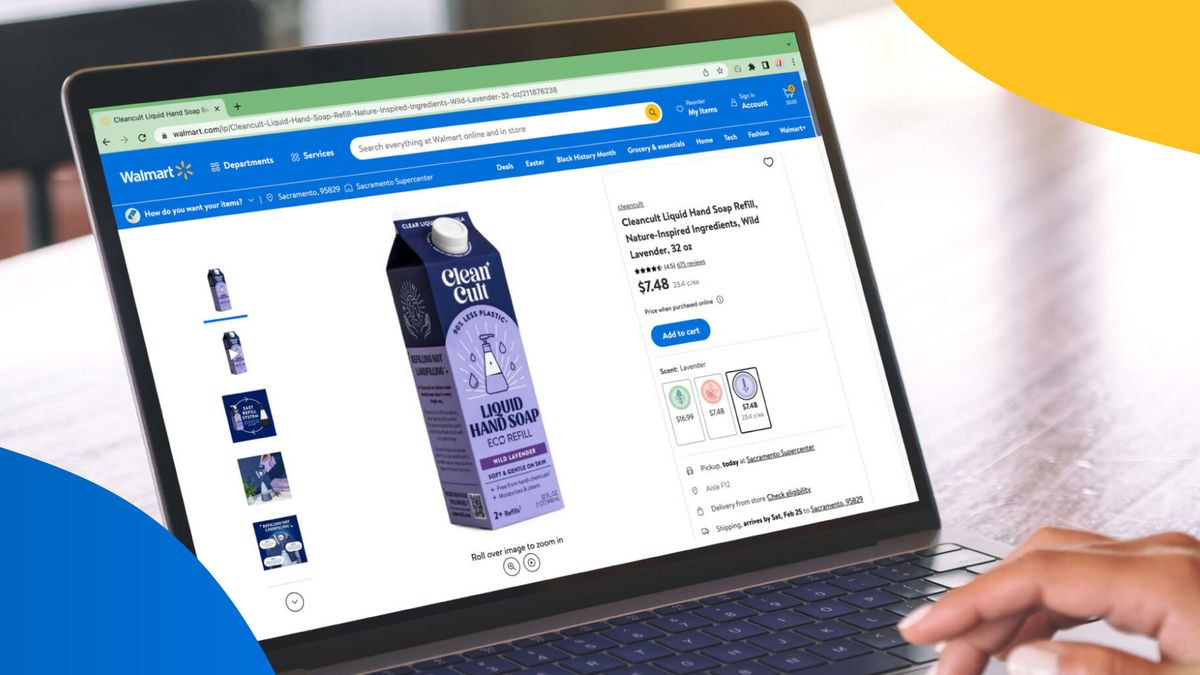 A close shot of fingers typing on the keyboard of a laptop with a picture of a milk carton on the walmart website