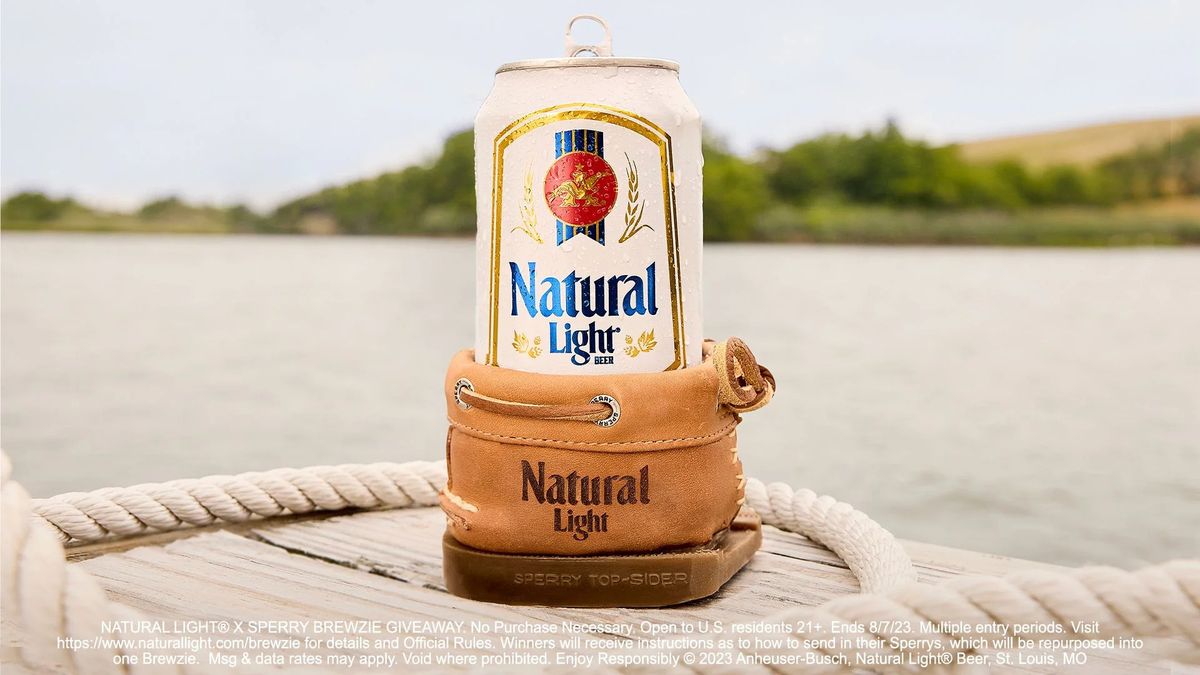A can of Natural Light sits in a brown boat shoes