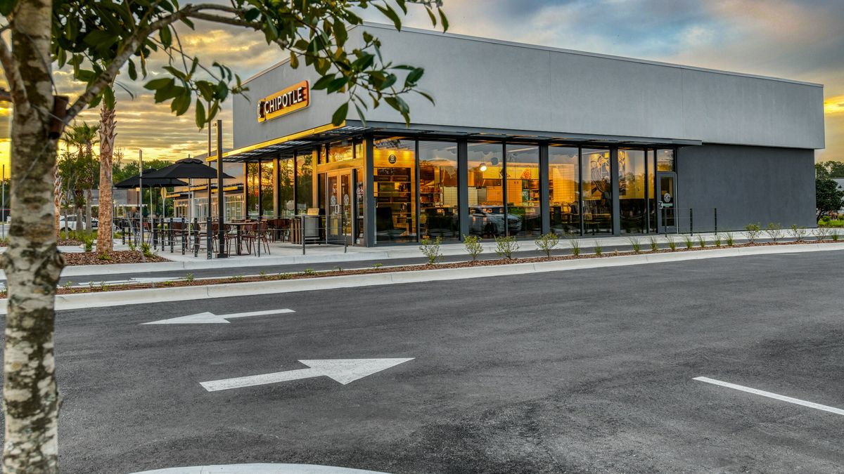A photograph of a standalone Chipotle around dusk.