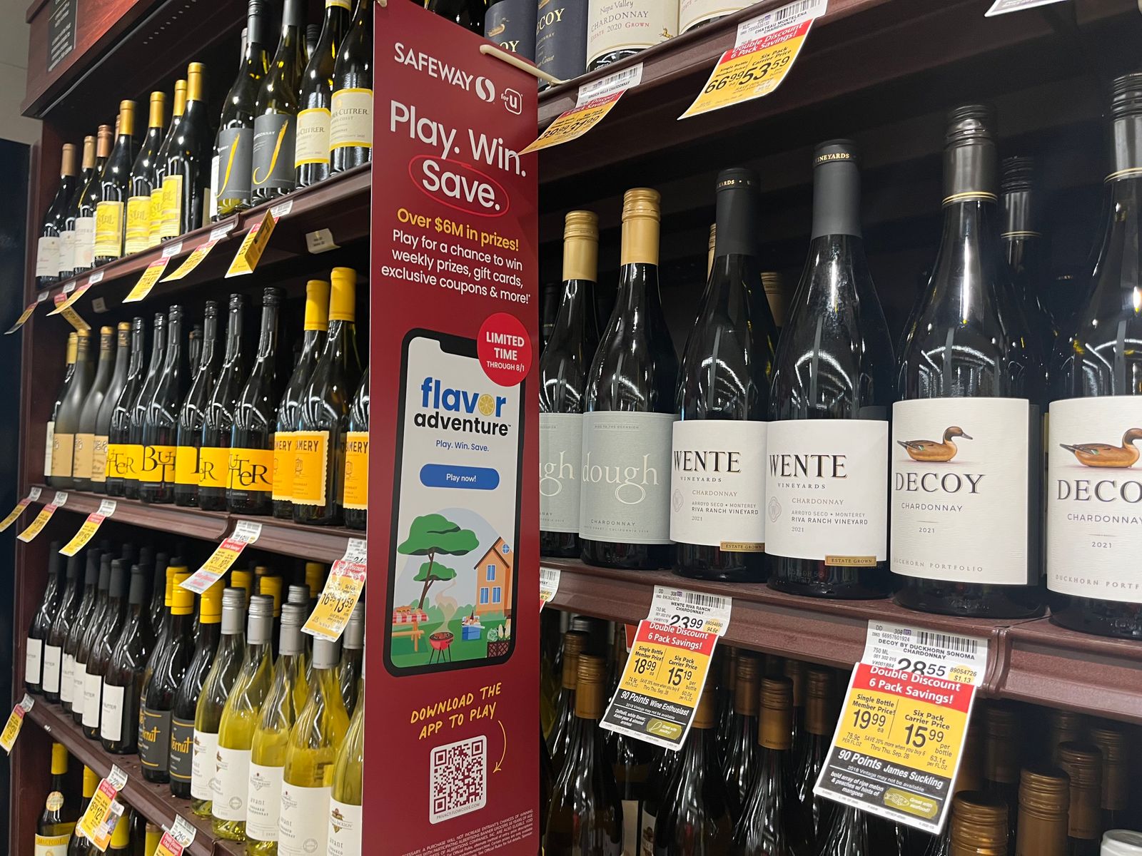 A sign for Albertsons' Flavor Adventure game in an alcohol aisle
